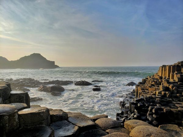 brown rocks on sea shore during daytime