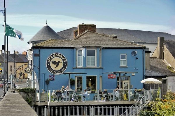 a blue building with a restaurant on the top of it